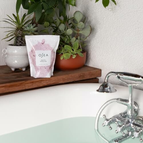 Bath scene with plants and OSEA product near tub