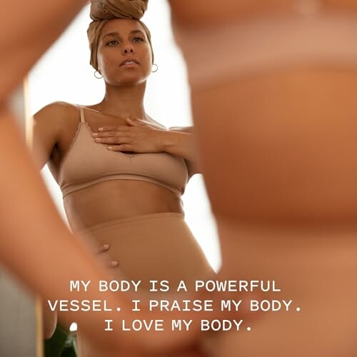 Woman in underwear looking at her reflection with empowering text.