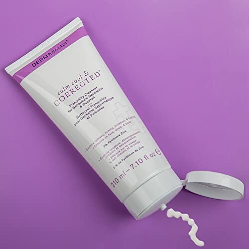 DERMAdoctor cleanser tube on purple background.