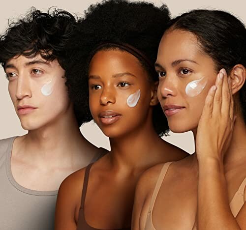 Three diverse individuals applying skincare cream on their faces.