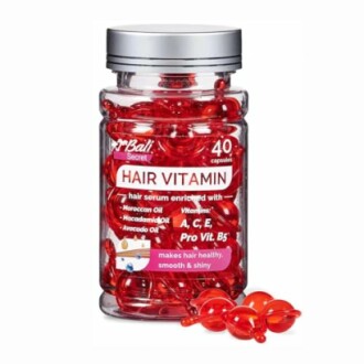 Bottle of hair vitamin capsules with red capsules inside