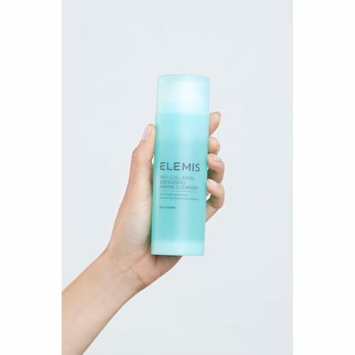 Hand holding Elemis Pro-Collagen Marine Cleanser bottle