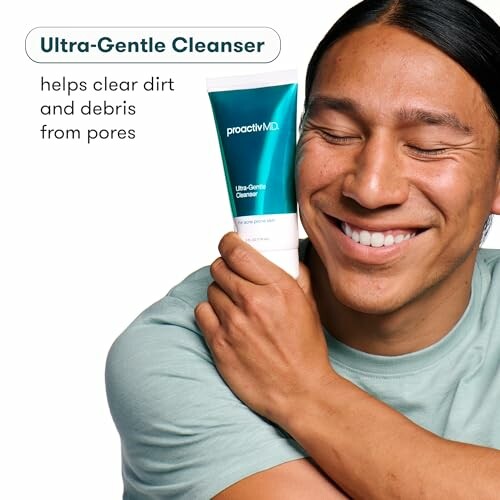 Man smiling and holding ProactivMD Ultra-Gentle Cleanser.