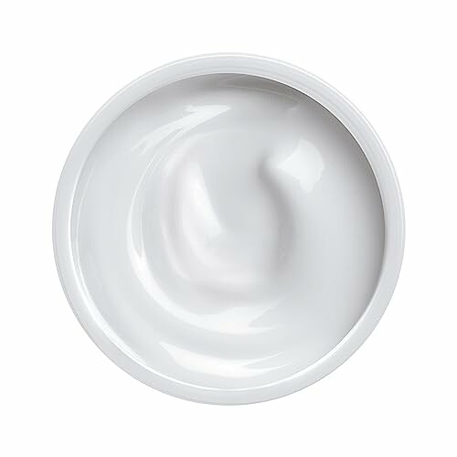 Top view of a white skincare cream in a container