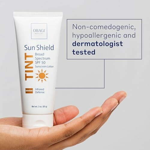 Hand holding a tube of Sun Shield sunscreen lotion with text about product benefits.