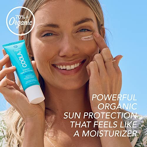 Woman applying organic sunscreen to her face.