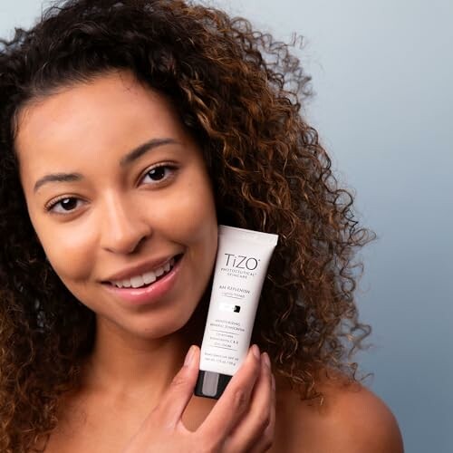 Woman holding a skincare product tube