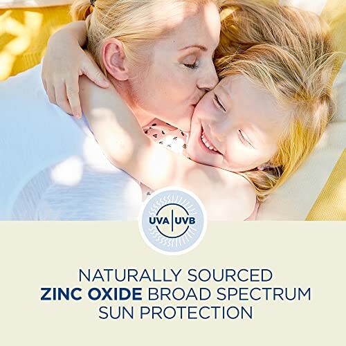 Mother cuddling child with zinc oxide sun protection message.